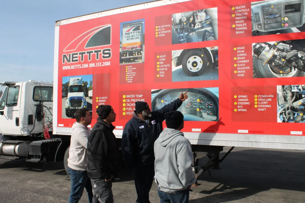 A CDL instructor pointing to pictures of different semi parts